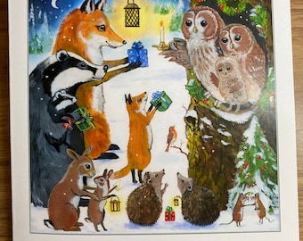 May include: A Christmas card featuring a woodland scene with animals exchanging gifts. A fox gives a blue gift box to a badger, while a fox cub holds a green gift box. Two owls sit in a tree with a wreath, and a hedgehog, rabbit, and mouse are also present. The card has a snowy background and a starry night sky.