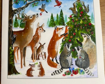 May include: A wintery Christmas scene with a deer, fox, raccoon, and rabbits gathered around a decorated Christmas tree. The tree is adorned with ornaments, lights, and a star on top. The animals are all looking at the tree with a sense of wonder and joy.