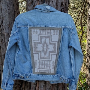 May include: A set of three ceramic mugs with a speckled, matte finish. The mugs are in shades of cream, light gray, and dark gray. Each mug has a simple, minimalist design, perfect for coffee or tea.