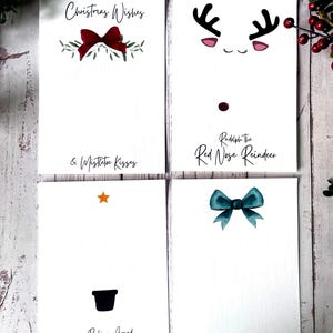 May include: Four printable Christmas card designs. The first card features a red bow with green leaves and the text "Christmas Wishes & Mistletoe Kisses". The second card features a cartoon reindeer with a red nose and the text "Rudolph The Red Nose Reindeer". The third card features a black silhouette of a Christmas tree with a star and the text "Rocking Around The Christmas Tree". The fourth card features a teal bow and the text "Jingle Bells".