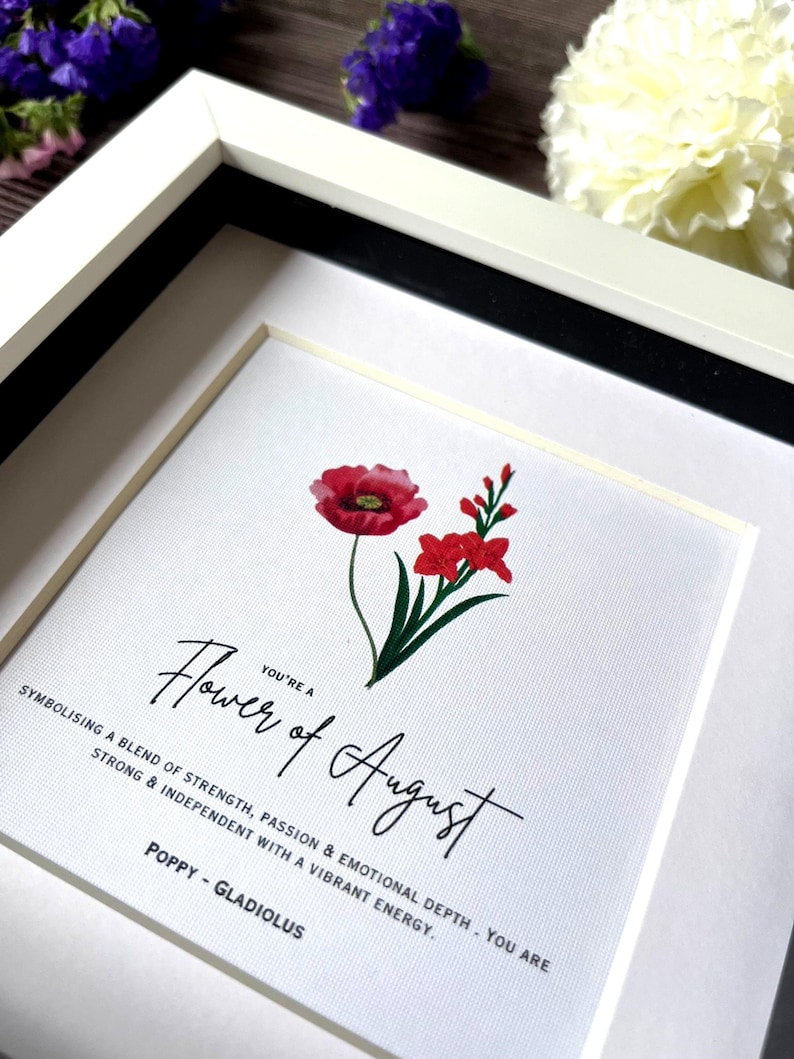 May include: A framed print with a red poppy and a pink gladiolus flower. The text reads "You're a Flower of August.  Symbolising a blend of strength, passion & emotional depth - you are strong & independent with a vibrant energy. Poppy - Gladiolus"