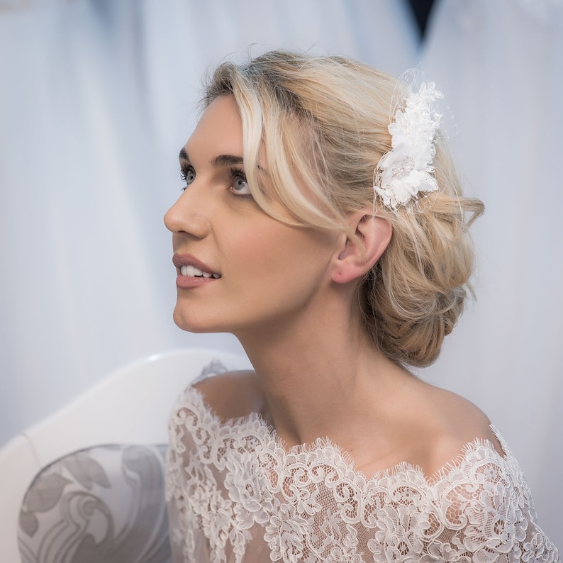 attached to a comb. A hair piece made of lace and crystals
