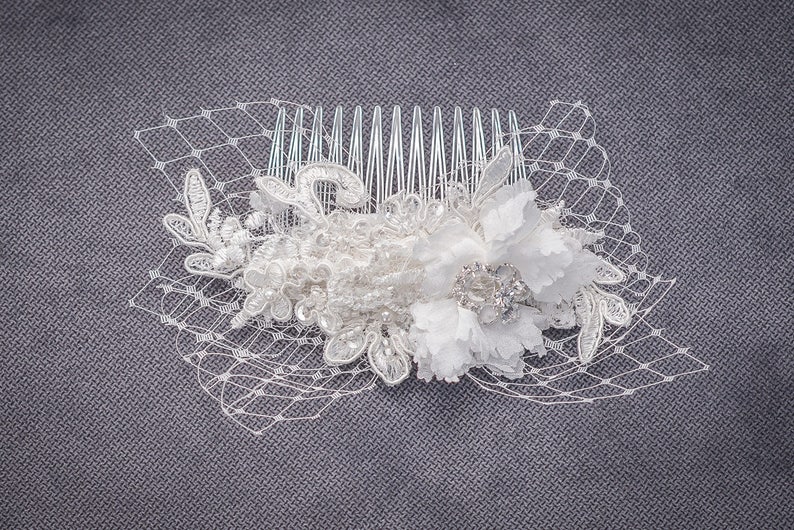 attached to a comb. A hair piece made of lace and crystals