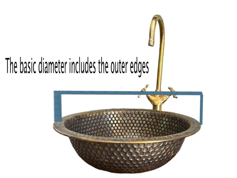 Custom made handmade brass sink: hammered copper bowl with rustic texture, tall luxe brass faucet on a wooden countertop.