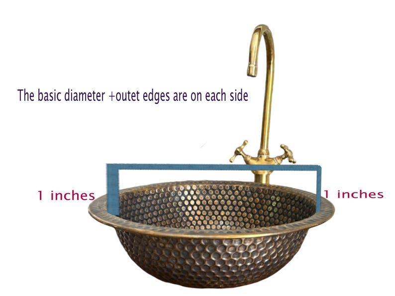 Custom made handmade brass sink: hammered copper bowl with rustic texture, tall luxe brass faucet on a wooden countertop.