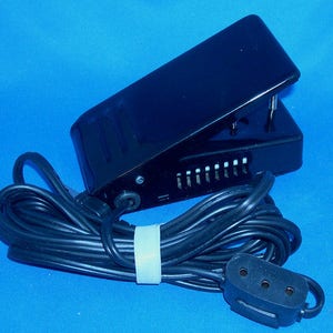 May include: Black foot pedal for a sewing machine with a black cord and a three-prong plug.