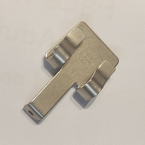 May include: A silver metal brake caliper clip with the text "CIRCUIT USA 91309" on the side.