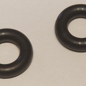 May include: Two black rubber O-rings. The O-rings are round and have a smooth surface.