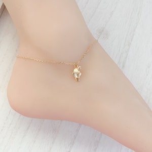 May include: A gold chain anklet with a small cactus charm. The anklet is delicate and dainty, perfect for adding a touch of whimsy to any outfit.