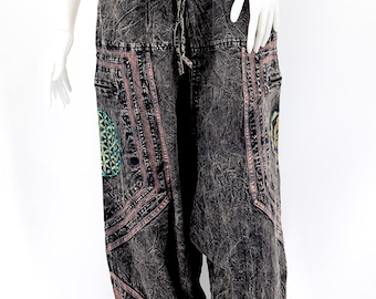 May include: Black and brown patterned pants with a drawstring waist and geometric embroidery. The pants have a loose, baggy fit.