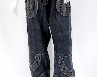 May include: Black cotton pants with embroidered details. The pants have a drawstring waist and a relaxed fit.