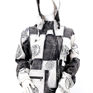 May include: A black and white patchwork hooded jacket with a zipper closure and various embroidered designs. The jacket has a large pocket on the front with a zipper.