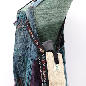 May include: A blue and black patchwork overall with a hemp bag and a black strap. The bag has a green leaf logo and the text "HIMALAYA HEMP FREE MADE IN INDIA".
