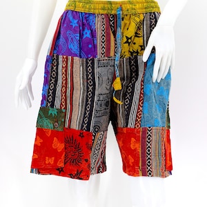 May include: Patchwork shorts with a colorful, multi-patterned design. The shorts have a drawstring waist and multiple pockets.