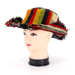 May include: A colorful striped hat with a frayed edge. The hat is made of woven fabric and has a wide brim.