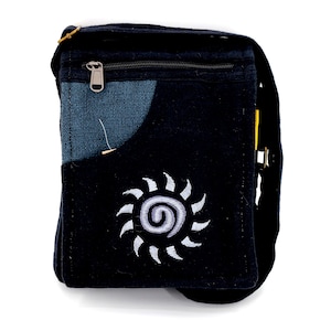 May include: Black canvas shoulder bag with a zippered pocket and a white embroidered sun design.