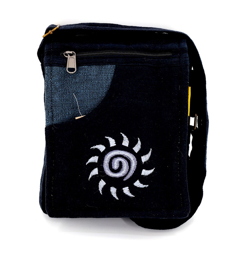 May include: Black canvas shoulder bag with a zippered pocket and a white embroidered sun design.