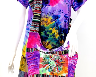 May include: A colorful tie-dye shoulder bag with a sun and moon design. The bag has a long strap with a woven pattern.
