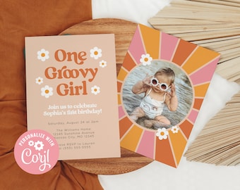 May include: A pink and orange birthday invitation with a groovy font and a white daisy pattern. The invitation says "One Groovy Girl" and includes details for a first birthday party. A separate card features a photo of a baby girl wearing sunglasses and a swimsuit in a circle with a pink and orange sunburst pattern.