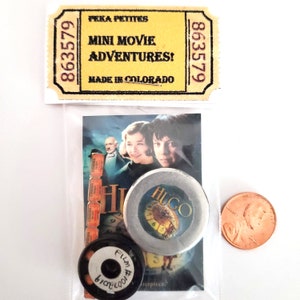 Miniature Movie Poster & Accessory Set with mini film reel and can. 1:12 scale dollhouse collectable Hugo
