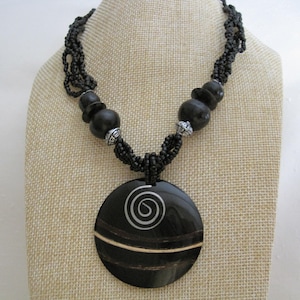 African Ethnic Tribal Necklace. Black Horn Pendant, Silver Metal Spiral & Coconut Stripe Inlaid, Black Glass Multi Strands Beaded Necklace.