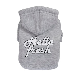 May include: Gray hooded sweatshirt for a pet with the text "Hella Fresh" in white on the back.