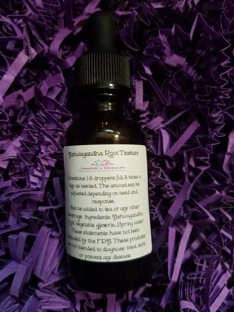 May include: A brown glass bottle with a black dropper top and a white label that reads "Ashwagandha Root Tincture" and "Jamilah's Naturals". The label also includes directions for use and a list of ingredients.