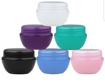 May include: Six small, round plastic containers with lids. The containers are in various colors: white, purple, green, black, blue, and pink.