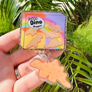 Dino Nuggets Badge Reel With Charm