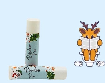 May include: Two white lip balm tubes with a blue and green Christmas themed design. The label reads "Reindeer Poo".
