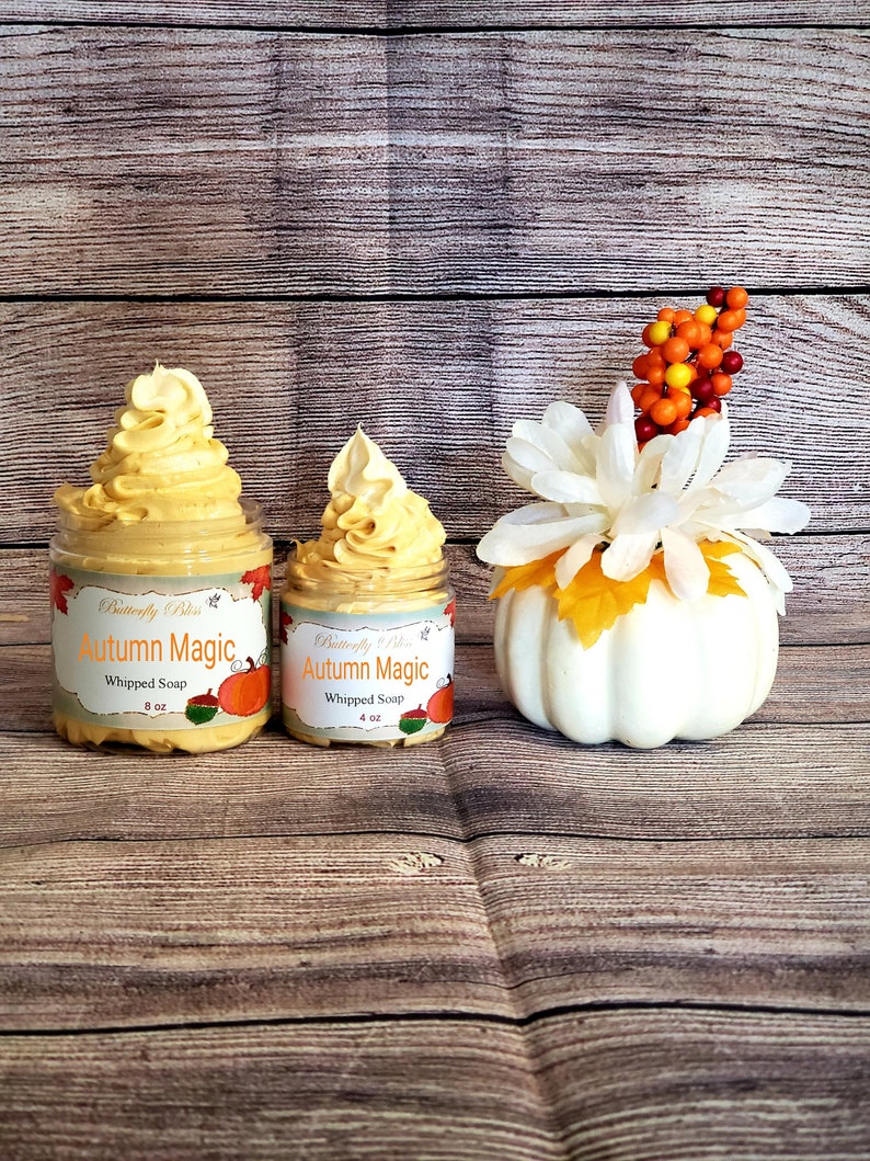 May include: Two jars of whipped soap with a fall theme. The jars are labeled "Autumn Magic" and are decorated with a pumpkin and fall leaves. The larger jar is 8 oz and the smaller jar is 4 oz.