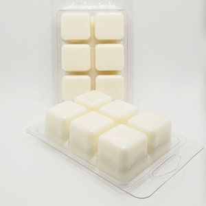 May include: A clear plastic tray with nine white wax melts. The wax melts are in a grid pattern and are ready to be used in a wax warmer.