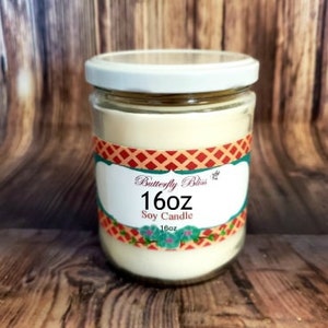 May include: A 16 ounce soy candle in a clear glass jar with a white lid. The label is red, white, and blue with the text "Butterfly Bliss" and "16oz Soy Candle".
