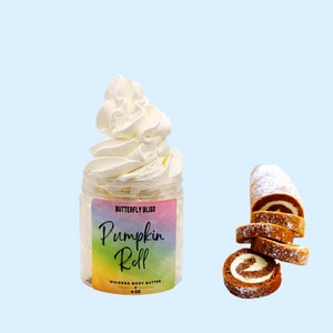May include: A 4 oz jar of whipped body butter with a white swirl on top. The jar has a rainbow label that says "Butterfly Bliss Pumpkin Roll Whipped Body Butter".  A pumpkin roll is sliced and arranged on a blue background.