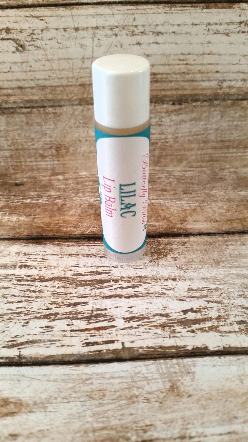 May include: A white tube of lip balm with a teal and white label that says "Butterfly Bliss" and "Lilac Lip Balm".