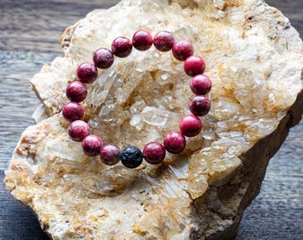 Thulite bracelet on elastic band with 1 black Lava bead. Norwegian Thulite 10mm bracelet