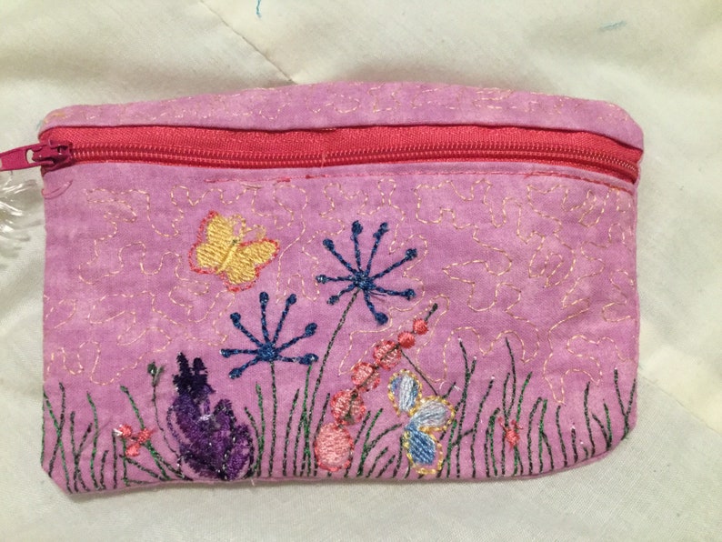 Pink in colored embroidered flowers with small Butterflies on it. 5.5 x 4.5 in size Embroidered bag
