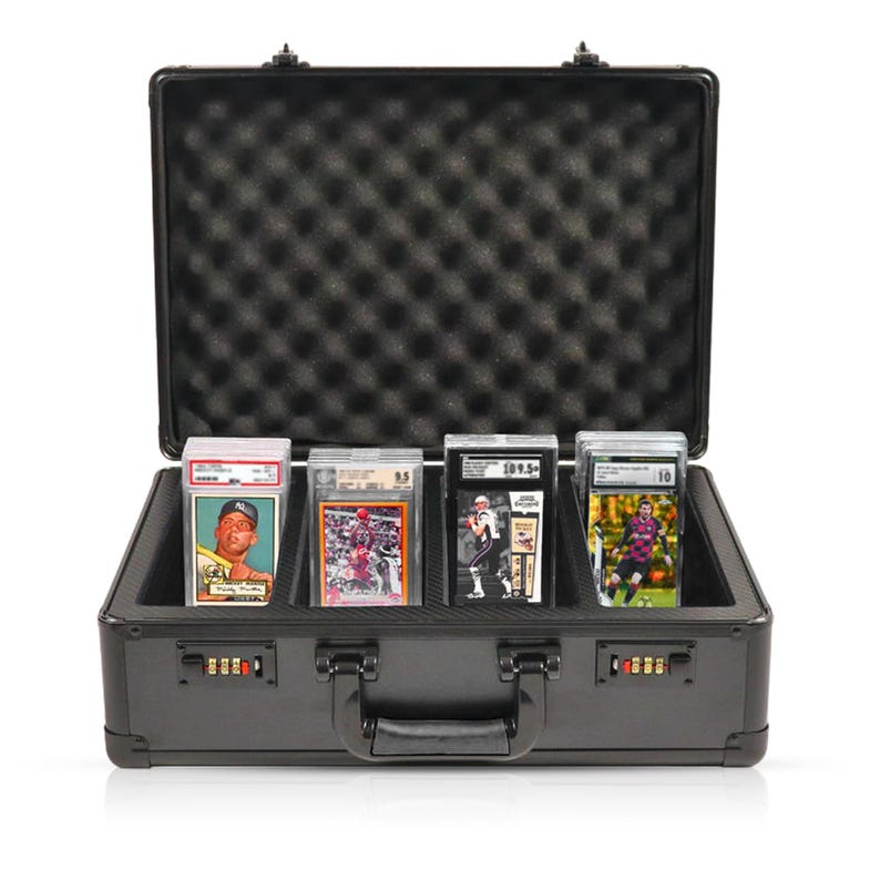 May include: Black hard-shell case with a combination lock and foam interior for storing and protecting trading cards. The case has a handle and is open to reveal five trading cards.
