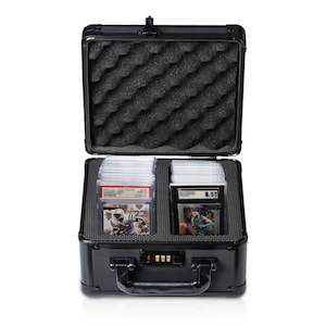 May include: Black aluminum case with a combination lock, designed to store and protect trading cards. The case is open, revealing a foam interior and rows of trading cards.