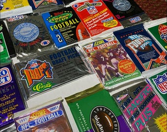 May include: A collection of vintage NFL trading cards from the 1990s. The cards feature various teams and players, including the 1991 NFL Pro Set, 1991 Stadium Club, 1991 Pacific Pro Football Plus, 1992 Game Day, 1991 Upper Deck, 1990 Score, and 1991 NFL Draft Picks.