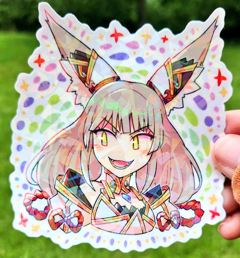 May include: A holographic sticker featuring a detailed anime-style character with large, pointed ears and a mischievous grin. The character is adorned with ornate, geometric designs and vibrant colors, set against a backdrop of colorful shapes and stars.