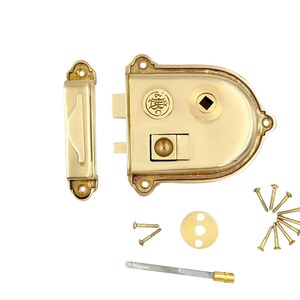 May include: A brass-colored door lock set with a rectangular strike plate, a main body with a keyhole and a circular emblem, and several screws. The set includes a small, round plate and a metal rod.