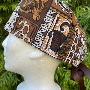May include: A brown and white patterned surgical scrub hat with a brown ribbon tie. The hat features a geometric design with a turtle and other symbols.