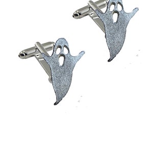 May include: Two silver ghost cufflinks. Each cufflink features a ghost-shaped design with cut-out eyes and mouth, attached to a silver bar. The cufflinks are presented on a white background.