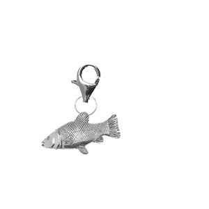 May include: A silver charm in the shape of a fish with a silver lobster clasp.