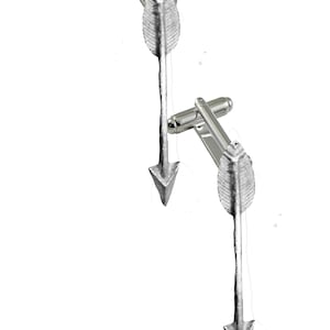 May include: A pair of silver cufflinks with arrowhead designs. The arrowheads are textured and have a pointed tip.