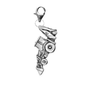 May include: Silver charm of a tractor with a detailed design. The charm has a lobster clasp for attaching to a bracelet or necklace.