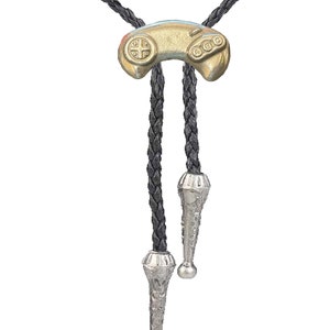 May include: A black bolo tie with a gold-colored video game controller pendant and silver-colored tips.