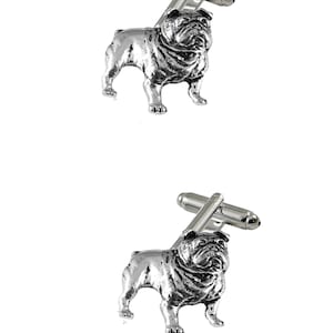 May include: A pair of silver bulldog cufflinks. The cufflinks are made of metal and feature a detailed bulldog design.