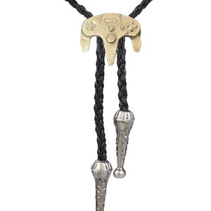 May include: A black leather bolo tie with a gold-colored Nintendo 64 controller charm. The ends of the tie are silver-colored and have a decorative design.